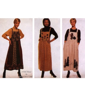 May include: Three women modeling different styles of long, patterned jumper dresses. The dresses feature various designs, including floral, geometric, and cartoon bear and tree motifs. The dresses have wide straps and pockets. The text "O'Dell House by Betty Sue O'Dell" is visible.