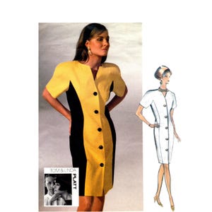 May include: A button-down dress with a color-block design in yellow and black. The dress has short sleeves and a V-neckline. The image also includes a fashion illustration of a similar white dress and the text "TOM & LINDA PLATT".