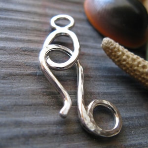 Hammered hook clasp. Handmade jewelry findings. Available in sterling silver and 14k gold filled. AGB Uranie.