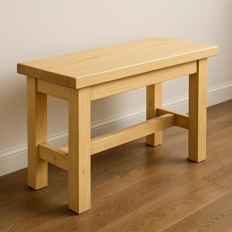Puede incluir: Un banco de madera natural con un dise&ntilde;o sencillo. El banco tiene una tapa rectangular y cuatro patas con una viga transversal para soporte.