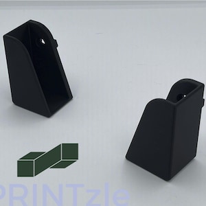 May include: Two black plastic corner brackets, each with a small hole in the top. The brackets are designed to be used to support shelves or other furniture.