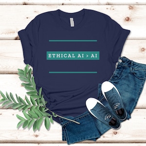 May include: Navy blue t-shirt with the text "ETHICAL AI > AI" in teal. The shirt is paired with blue jeans and navy sneakers with white soles. A sprig of green leaves is placed on the left side of the image.