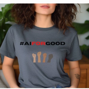 May include: A dark grey t-shirt with the text "#AIFORGOOD" in black and red.  Four raised fists are shown below the text, each a different skin tone.
