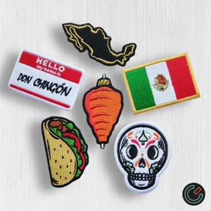 May include: A set of six embroidered iron-on patches featuring Mexican-themed designs. The patches include a taco, a skull, a spinning top, a map of Mexico, a Mexican flag, and a name tag that reads "HELLO my name is DON CHINGON".
