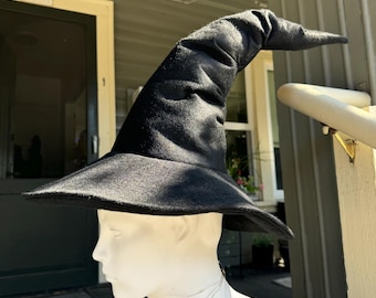 May include: A black felt witch hat with a tall, pointed crown and a wide brim.