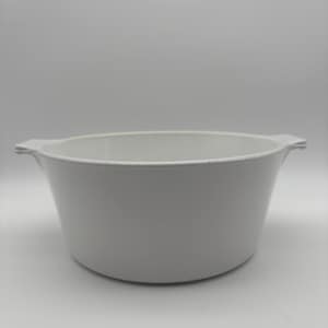 May include: A white, oval-shaped casserole dish with two small handles on either side. The dish has a simple, classic design and is made of a solid, opaque material. The interior is smooth and the exterior is slightly textured.