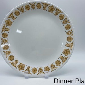 May include: White dinner plate with a gold floral pattern around the rim. The plate has a simple, elegant design, perfect for everyday use or special occasions. The text "Dinner Plate" is at the bottom of the image.