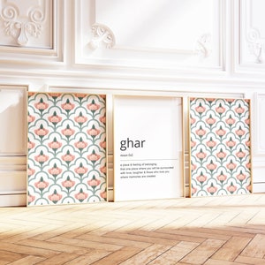 May include: Three framed prints featuring a pink and green floral pattern. The centre print defines the word "ghar" as "a place & feeling of belonging, that one place where you will be surrounded with love, laughter & those who love you, where memories are created."