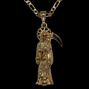 May include: A gold chain necklace with a pendant featuring a detailed depiction of the Grim Reaper holding a scythe. The Reaper has red eyes and a skull-like face.