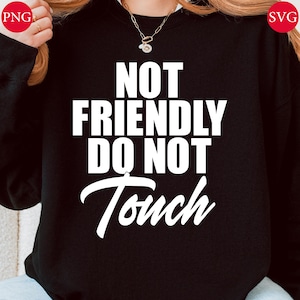 May include: Black sweatshirt with the white text "NOT FRIENDLY DO NOT Touch". The text is in a bold, sans-serif font, with the word "Touch" in a cursive font. The sweatshirt is a solid black color.