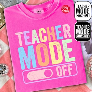 May include: A bright pink t-shirt with the words "TEACHER MODE OFF" in a colorful, distressed font. The design includes a toggle switch graphic. Additional small graphics with the same text are in the upper right corner. The shirt is made of a soft material.