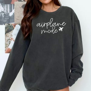 May include: A dark gray sweatshirt with the text "airplane mode" in white lettering and a small airplane icon.