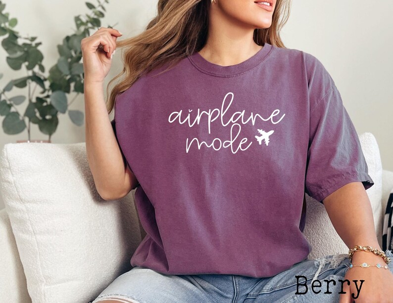 May include: A purple t-shirt with the text "airplane mode" in white script with a small airplane graphic.