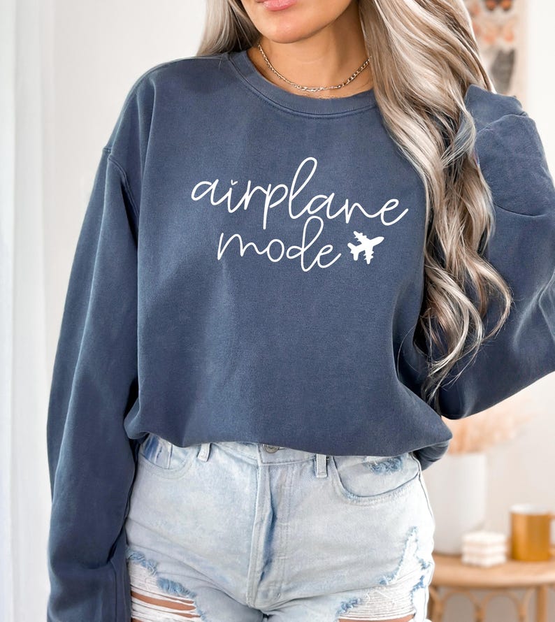 May include: A dark blue sweatshirt with the text "airplane mode" in white lettering and a small airplane graphic.