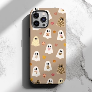 May include: A brown iPhone case with a pattern of white ghosts and various brown and orange shapes. The case has a camera cutout and a cutout for the phone's buttons.