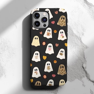May include: Black phone case with a pattern of white ghosts, brown and orange candy, and hearts. The case has a camera lens cutout.
