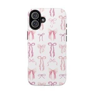May include: A white phone case with a pink and white watercolor bow pattern. The case has a cutout for the camera lens.