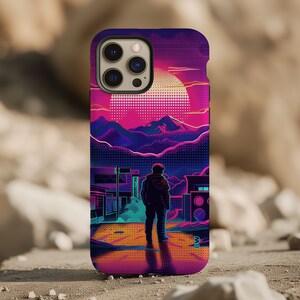 May include: A phone case with a retro-futuristic design featuring a silhouette of a person standing in a city landscape with a sunset in the background. The case has a black border and a purple, pink, and blue color scheme.