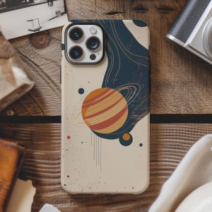 May include: A phone case featuring a celestial design. The case has a cream-colored background with a planet illustration in shades of orange and brown, surrounded by a blue and gold abstract design. The case is designed to fit a smartphone.