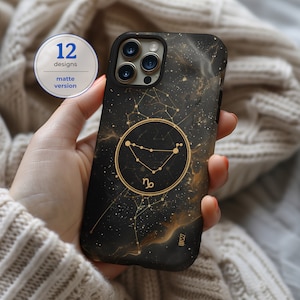 May include: Black phone case with a gold glitter design and a gold Capricorn zodiac symbol. The case has a matte finish and says "12 designs, matte version".