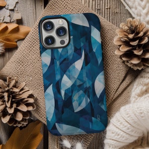May include: A blue and white geometric phone case with a camera lens cutout. The case has a modern abstract design with a subtle shimmer.
