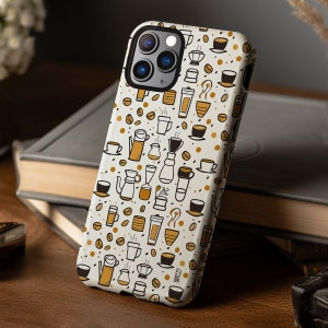 May include: A white iPhone case with a brown and white coffee themed design. The case features illustrations of coffee cups, coffee beans, and coffee makers.