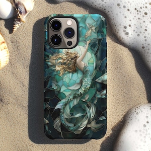 May include: A smartphone case featuring a stained glass style illustration of a mermaid with long flowing hair and a shimmering green tail. The design incorporates deep teal and blue geometric segments, with small fish swimming around the figure.