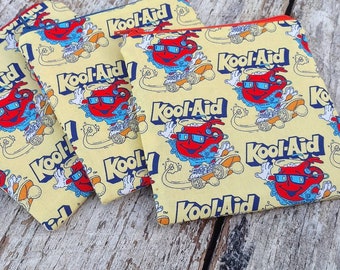 Retro Kool-Aid man themed square zipper pouches. Oh yeah! Soft drinks. Fabric change purse. Gift idea. Skateboard fun. Old commercials.