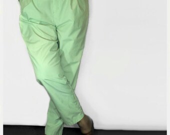 May include: A pair of light green high-waisted pants with a pleated front.