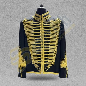 May include: A black jacket with gold trim and buttons. The jacket has a stand-up collar and a row of gold buttons down the front.