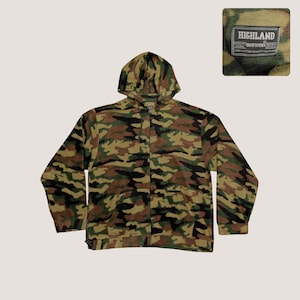 May include: A camouflage-patterned zip-up hoodie in shades of green, brown, and black. The hoodie features a drawstring hood, a full-length zipper, and a label that reads "HIGHLAND QUALITY OUTFITTERS ORIGINAL CLOTHING LONG LASTING QUALITY CLOTHING."