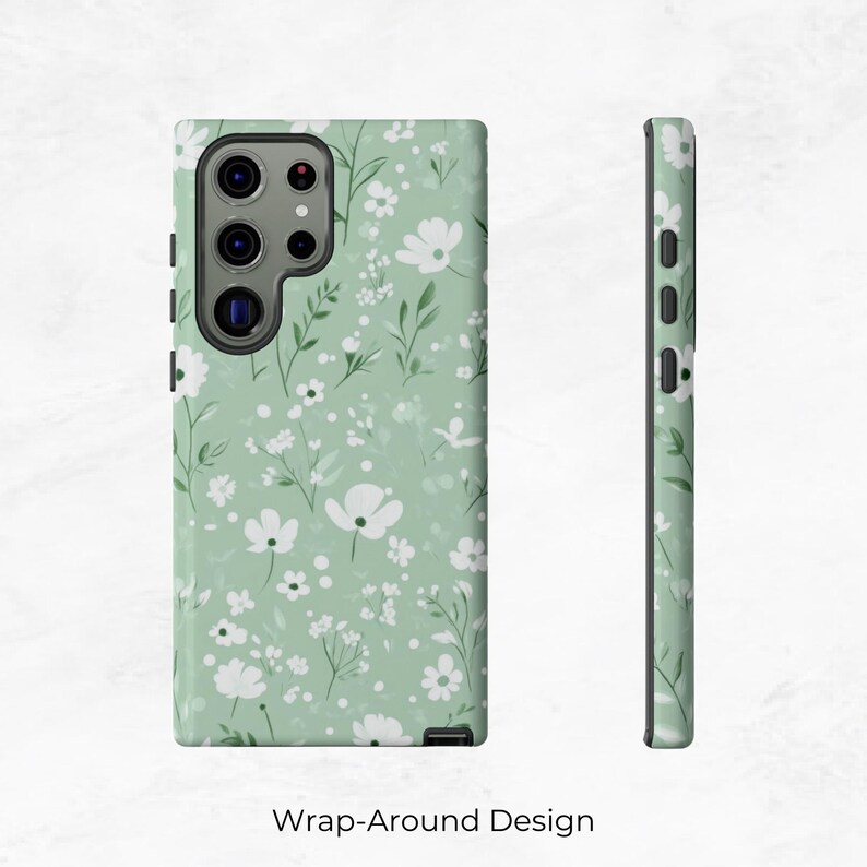 May include: A green phone case with a white floral pattern. The case has a wrap-around design.