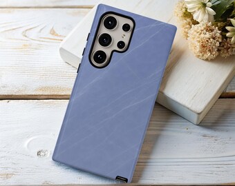 May include: A light blue phone case with a marble pattern. The case has a raised camera bump with three lenses.