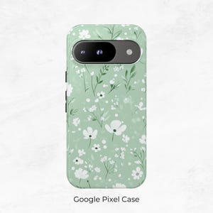 May include: A green phone case with a white floral pattern. The case has a camera cutout and a Google Pixel Case label.