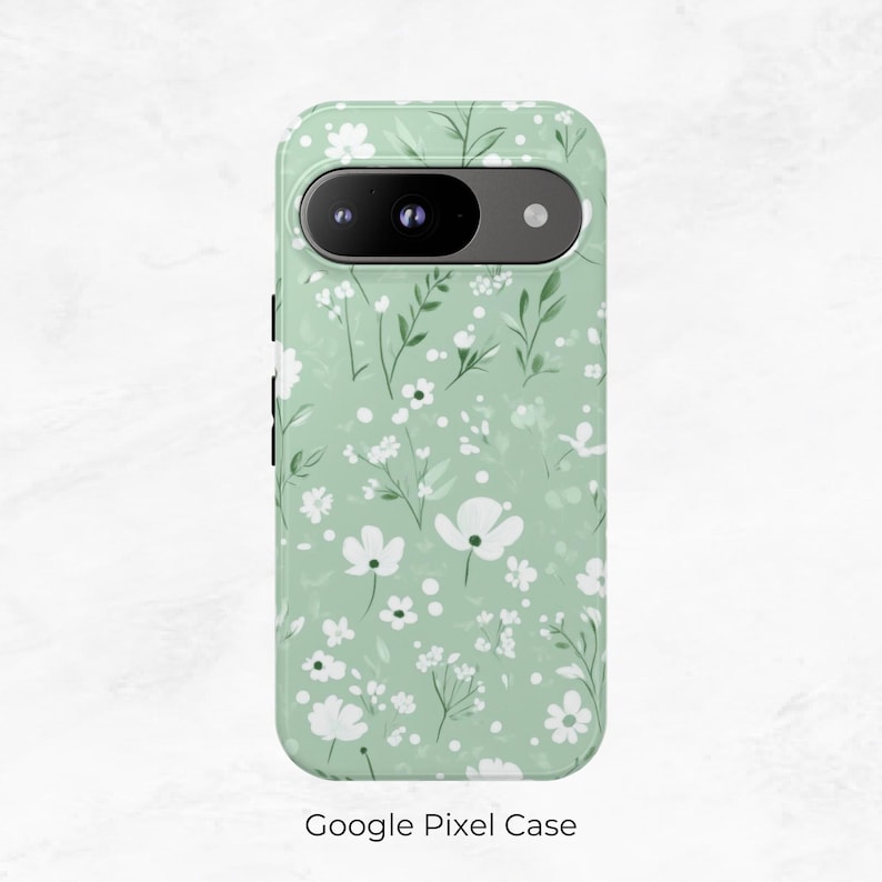 May include: A green phone case with a white floral pattern. The case has a camera cutout and a Google Pixel Case label.