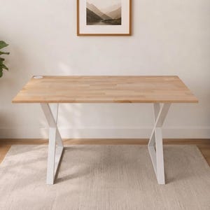 May include: A rectangular desk with a light-toned wood grain surface and a white metal frame featuring crossed legs. The desk includes a small circular integrated charging port on the top left corner of the tabletop, providing a functional workspace.
