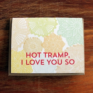 May include: A card with a white background and a pattern of colorful doilies. The text "HOT TRAMP, I LOVE YOU SO" is printed in red.