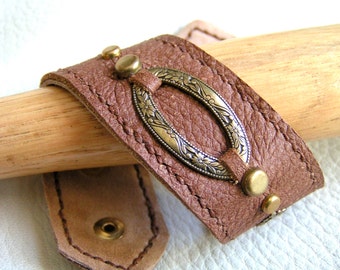 Stamped brass on brown leather cuff