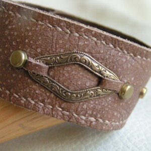 Stamped brass on light brown leather cuff
