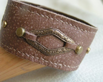 Stamped brass on light brown leather cuff