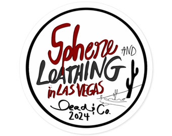 May include: A circular white sticker featuring the text "Sphere and Loathing in Las Vegas" in black and red. The sticker also includes "Dead & Co. 2024" and a desert landscape with a cactus.