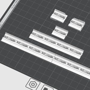 May include: Five pieces of white decorative moulding with a floral design. The moulding is arranged on a grey grid background.