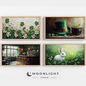 May include: Four framed art prints with a St. Patrick's Day theme. The prints feature shamrocks, a green top hat, a pub interior, and a white rabbit in a field of clover. The frames are made of light-colored wood.