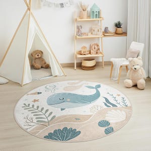Soft velvet-like nursery rug featuring a friendly whale, seaweed, and sandy ocean floor, made for safety and easy cleaning.