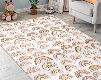 May include: A rectangular area rug with a repeating pattern of stylized rainbows in shades of brown, tan, and pink on a white background. The rug is made of a soft material and is suitable for a nursery or children's room.