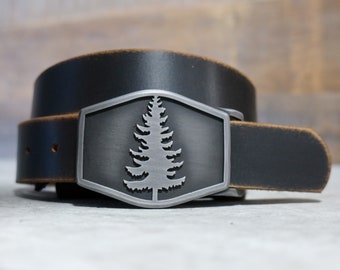 May include: A black leather belt with a silver buckle featuring a tree design.