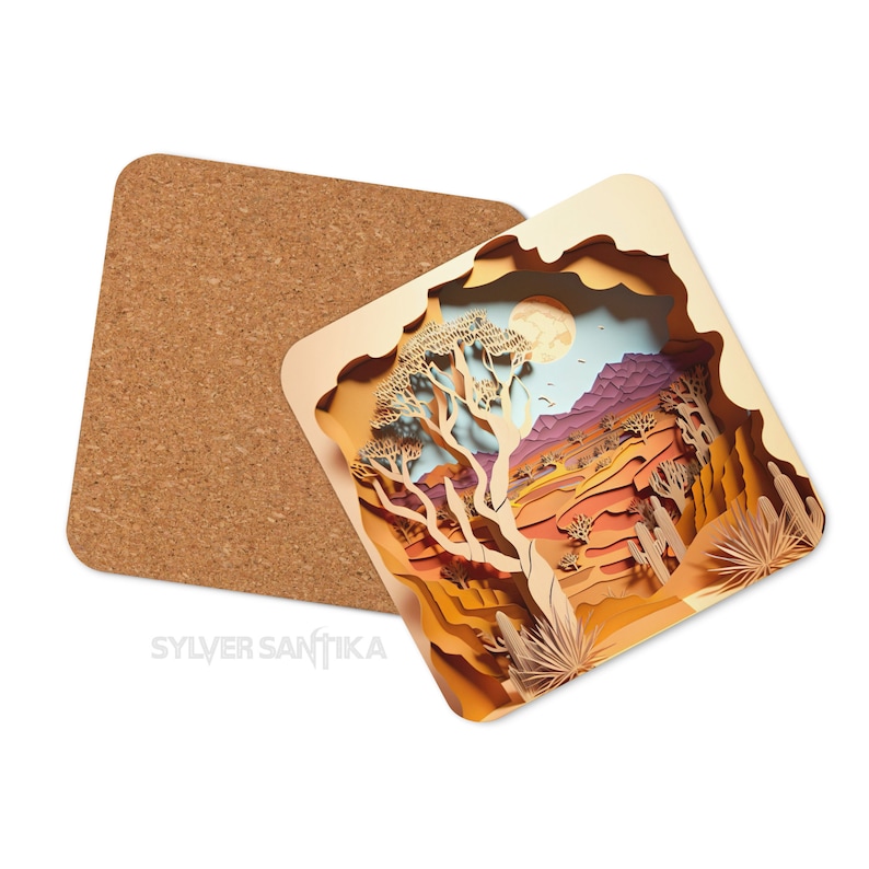 May include: A square cork coaster with a paper cut-out design of a desert landscape. The design features a large tree, mountains, and a full moon in the sky. The colors are mostly brown, orange, and yellow.