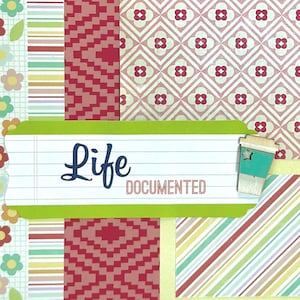 May include: A scrapbook page with various patterned papers in red, pink, green, and yellow. The text "Life Documented" is displayed on a white lined label with a green border. A small wooden coffee cup is attached to the label.