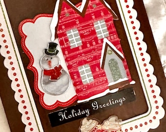Upcycled tile holiday decor with red house and snowman, vintage-inspired rustic wall art.