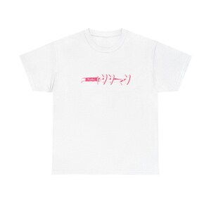 May include: White t-shirt featuring a pink graphic. The design includes the word "Yadie" and a series of stylized symbols. The shirt is made of a soft material and has a classic crew neck.